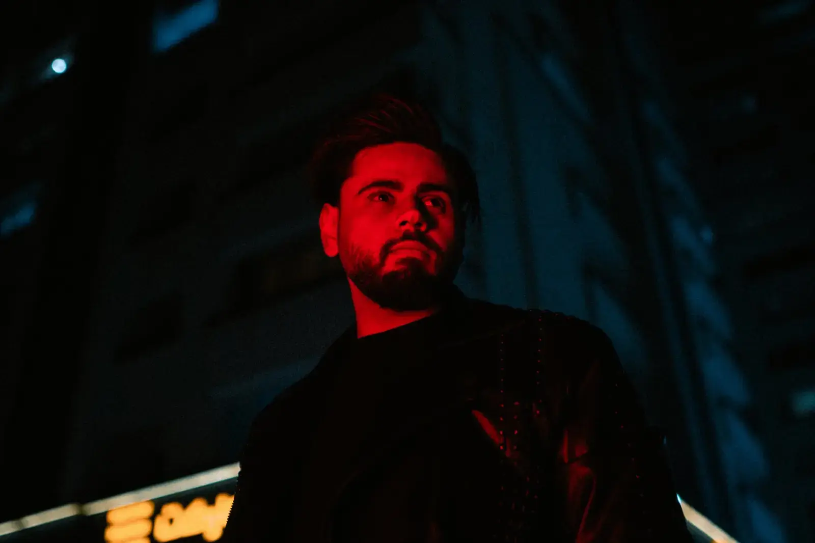 Karan Johar Locks 2028 Release for Real-Life Spymaster RN Kao Silhouette of a man walking down a dimly lit, moody city street at night