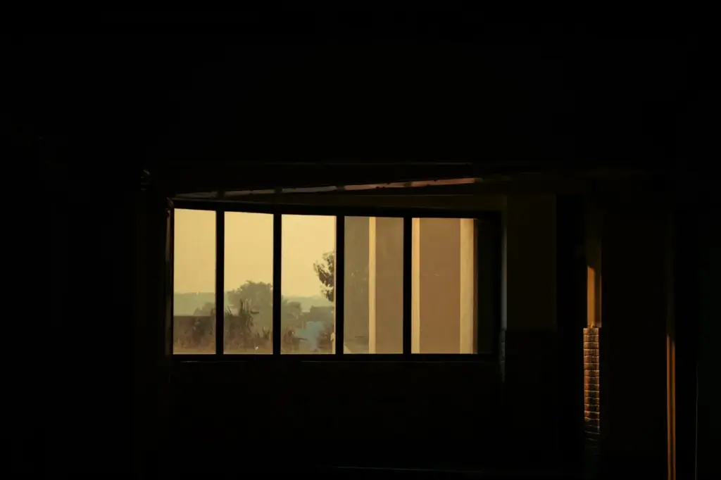 A serene view of sunset light illuminating a quiet room through a large window