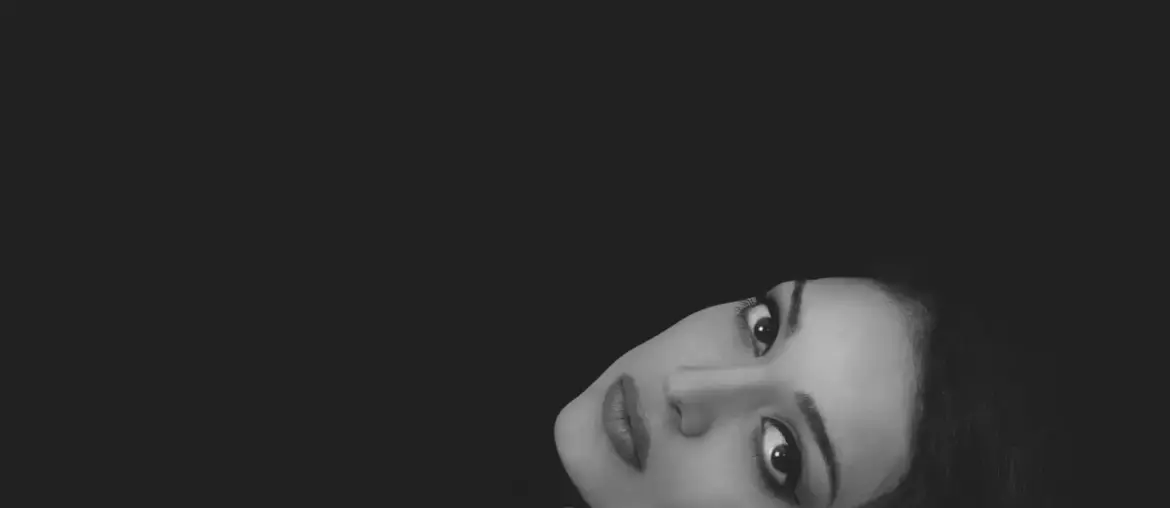 Black and white portrait of Tia Bajpai looking serious against a dark background