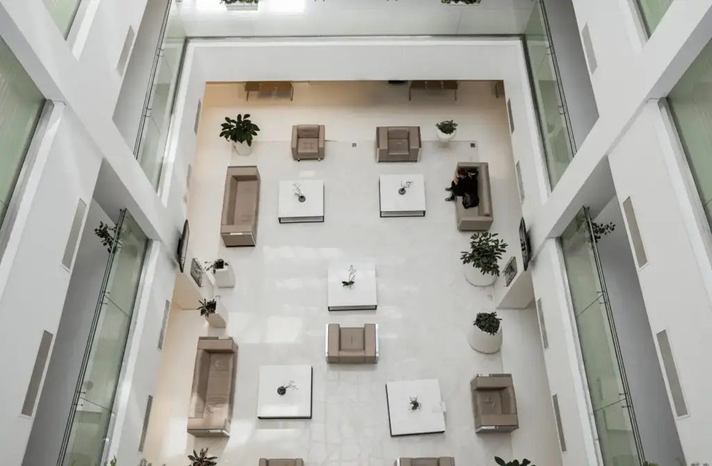 Aerial view of a contemporary lobby in Baku featuring stylish sofas, tables, and potted plants