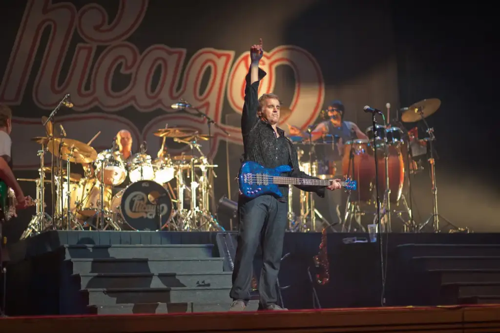 Energetic live concert show featuring musicians performing with drums, guitar, and bass