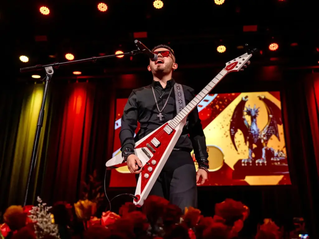 Energetic rock musician performing on stage with electric guitar and microphone under vibrant lights