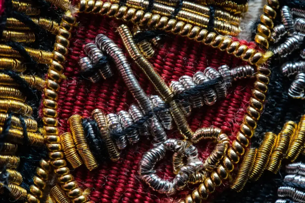 Intricate beaded embroidery with metallic threads and vibrant colors in close-up view