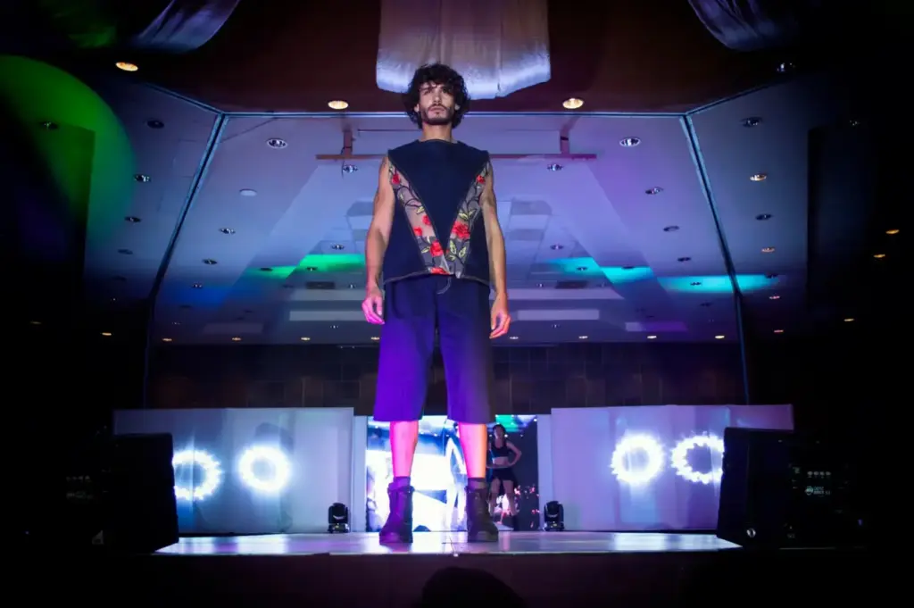 Male model on a vibrant fashion runway at an indoor venue in Morelia, Mexico
