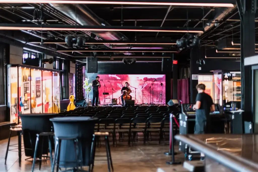 Musicians preparing on stage in an empty music venue, ready for a concert