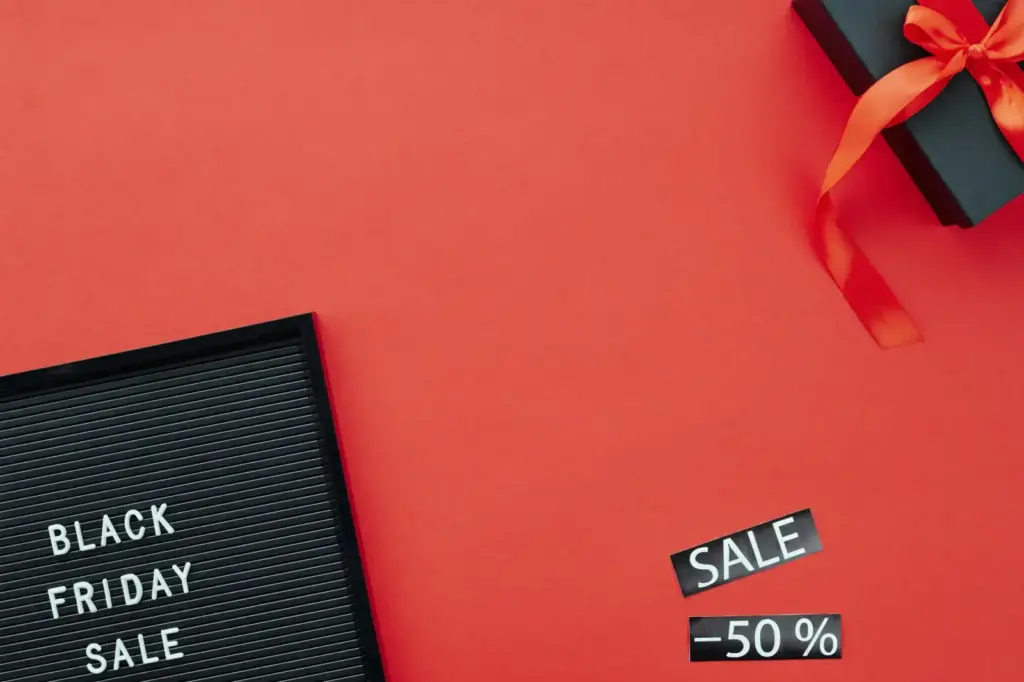 Red background featuring a Black Friday sale sign and gift box, ideal for promoting sales events