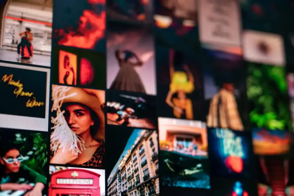 Various images of elegant people and building facade near creative titles hanging on wall in apartment as symbol of…