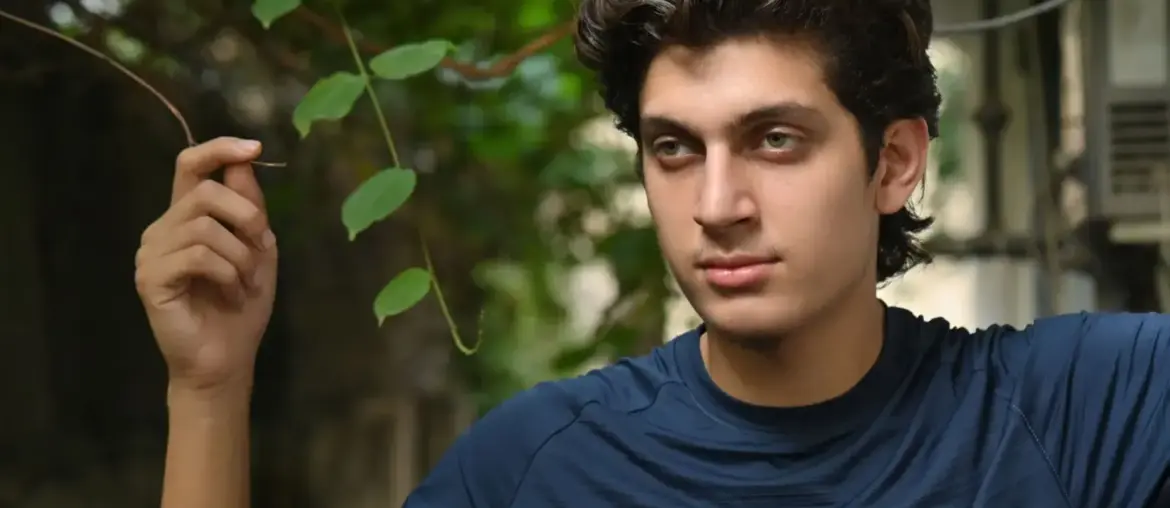 Young man posing outdoors in Islamabad with natural greenery background