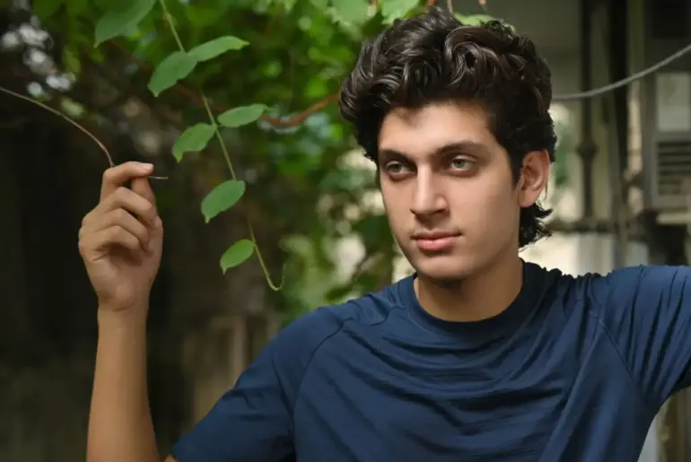 Young man posing outdoors in Islamabad with natural greenery background